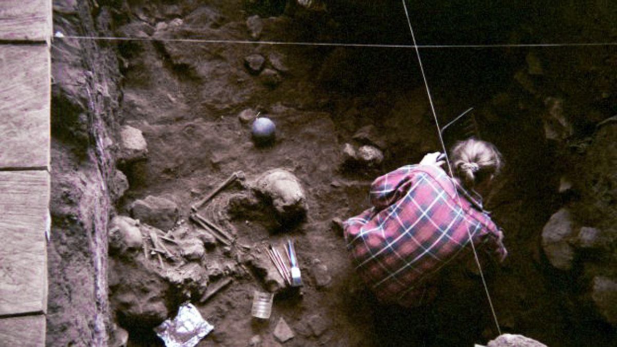A researcher excavates the ancient bones at the Shum Laka rock shelter, whi