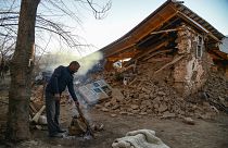 A villager stands by his collapsed house after an earthquake in Sivrice, ne