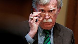Image: National Security Advisor John Bolton adjusts his glasses as U.S. Pr