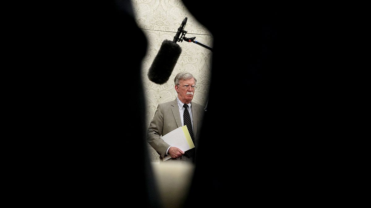 Image: National Security Adviser John Bolton listens in the Oval Office on 