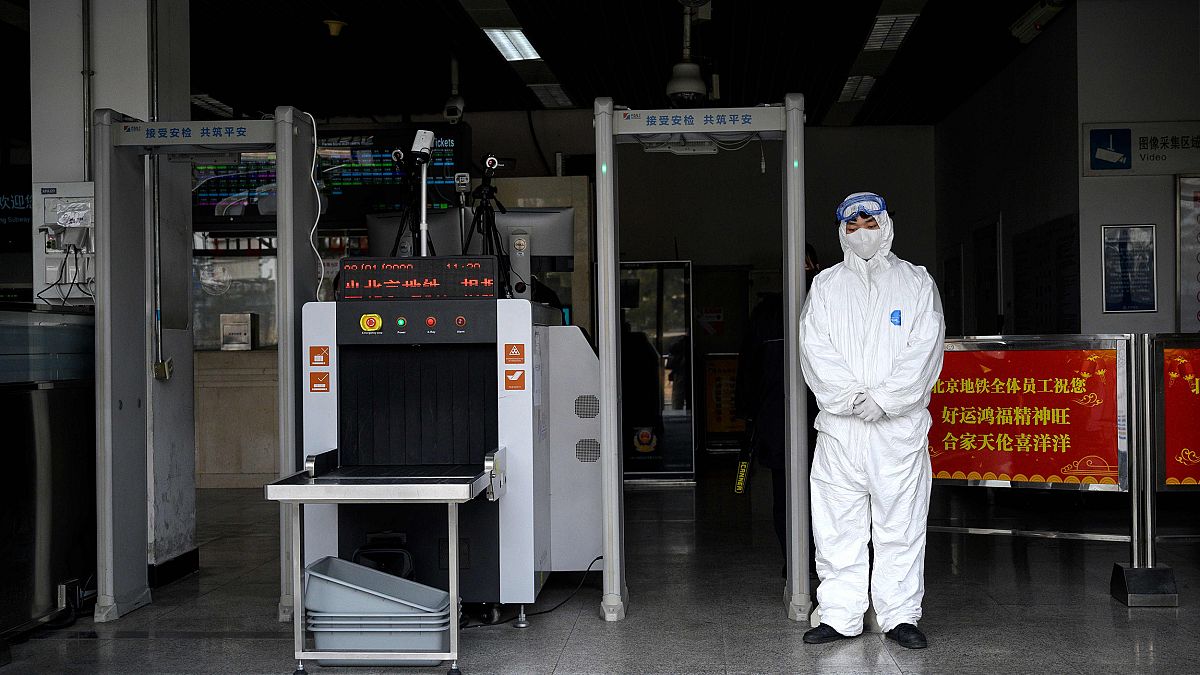 Image: Security personnel wearing protective clothing to help stop the spre