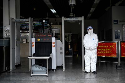Security personnel wearing protective clothing to help stop the spread of a deadly SARS-like virus at the entrance of subway station in Beijing on Jan. 28, 2020.