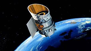 The Infrared Astronomical Satellite RAS) orbits the Earth in this illustrat