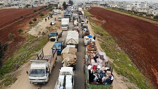 Image: Displaced Syrians driving through Hazano in the northern province of
