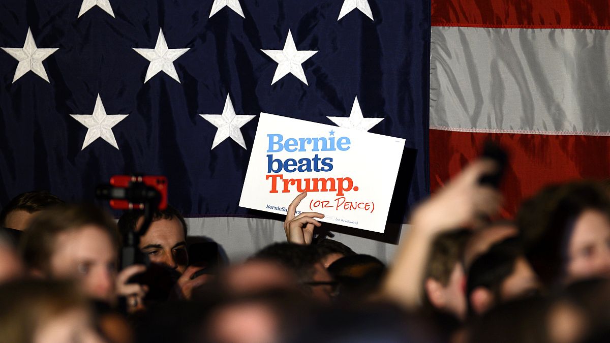Image: Supporters wave signs for Sen. Bernie Sanders, I-VT, at a campaign e
