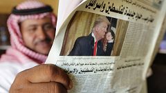Image: A man holds the daily Asharq Al-Awsat newspaper 