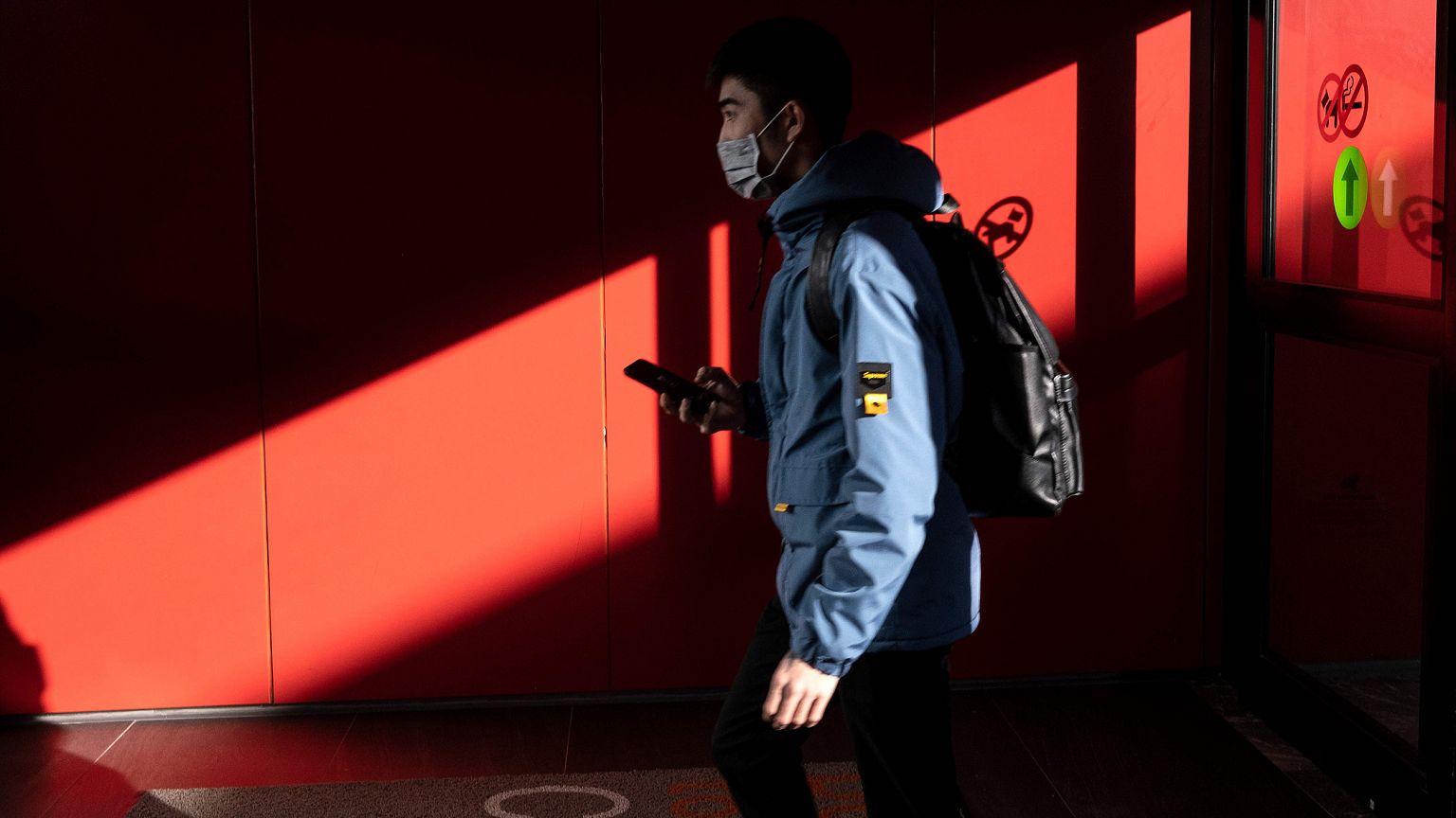 Image: A passenger from China's Hainan Airlines from Beijing walks out of t
