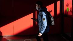Image: A passenger from China's Hainan Airlines from Beijing walks out of t