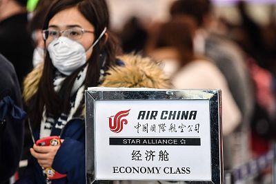 A passenger wearing a respiratory mask waits for check in on Jan. 31, 2020 in a terminal of Rome\'s Fiumicino airport.