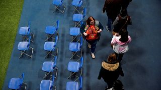 Image: People take part in a Caucus at Drake University in Des Moines