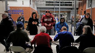 Iowans register at their caucus site in Des Moines on Feb. 3, 2020.