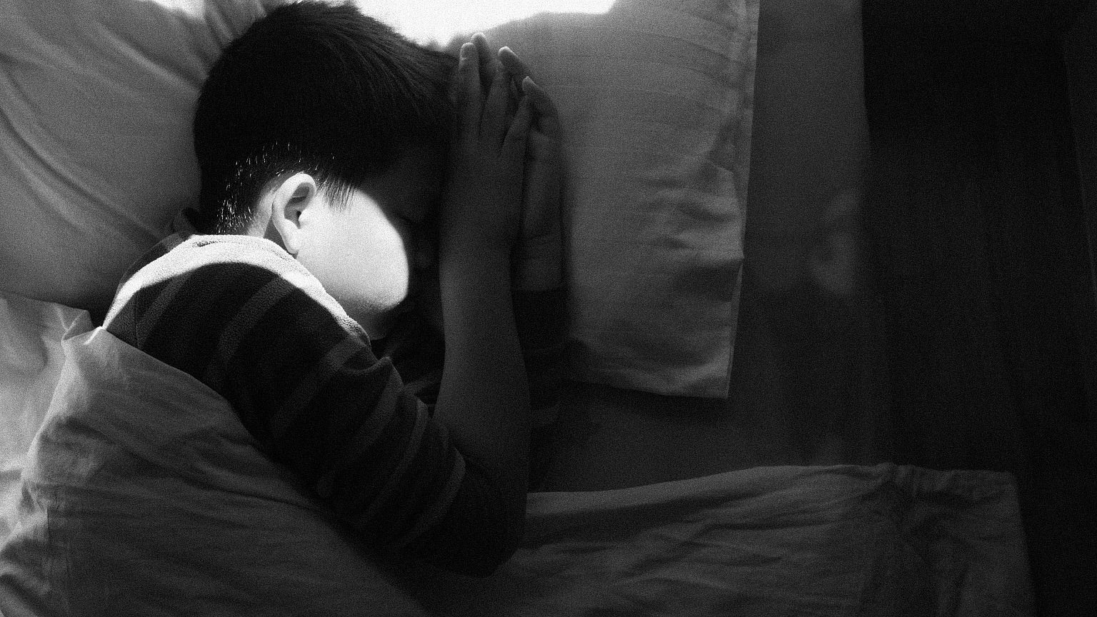 Image: boy asleep in bed