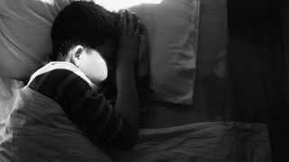Image: boy asleep in bed