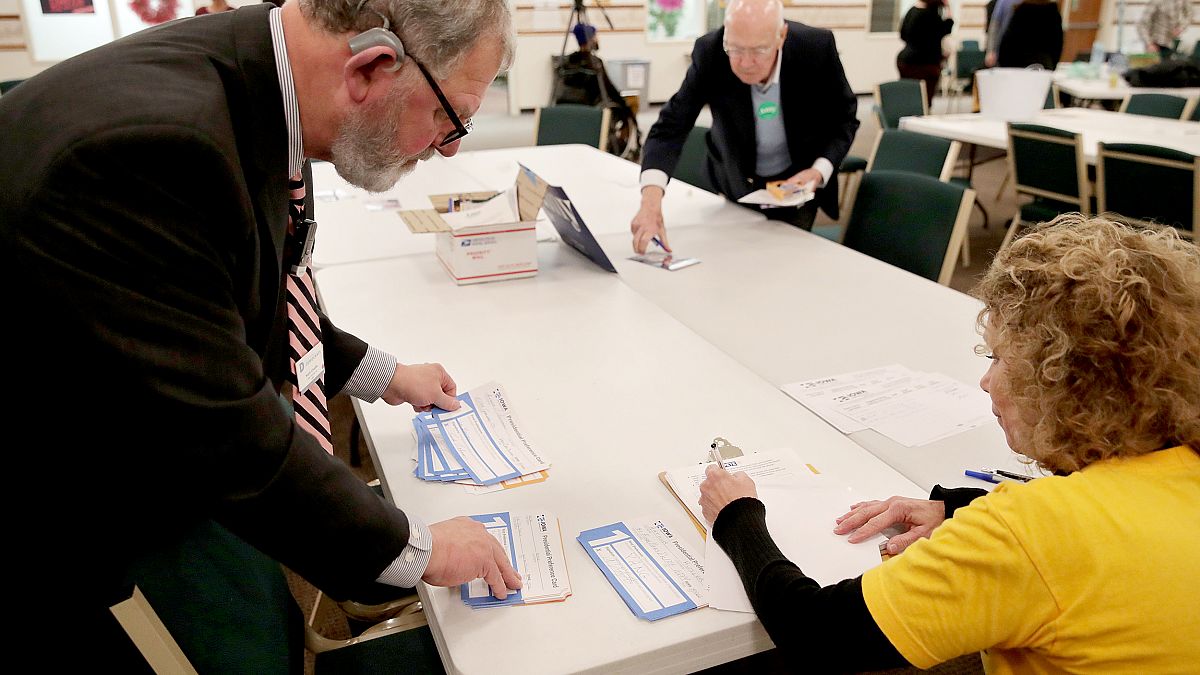 Image: Precinct workers tally Iowa Democratic Caucus votes by hand as caucu