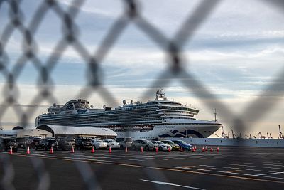 The Diamond Princess sits docked at Daikoku Pier where it is being resupplied and newly diagnosed coronavirus cases taken for treatment in Yokohama, Japan.