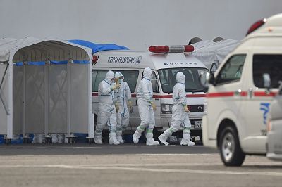 Medical staff wearing protective gear prepare to provide care for suspected coronavirus patients on board the quarantined Diamond Princess cruise ship in Yokohama on Friday.