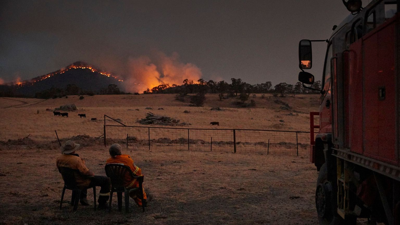 Image: Rural Fire Service volunteer firefighters watching as the New South 