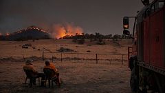 Image: Rural Fire Service volunteer firefighters watching as the New South 