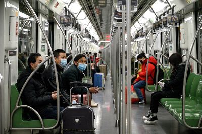 Passengers wearing protective face masks travel on a subway train in Shanghai, China on Sunday.