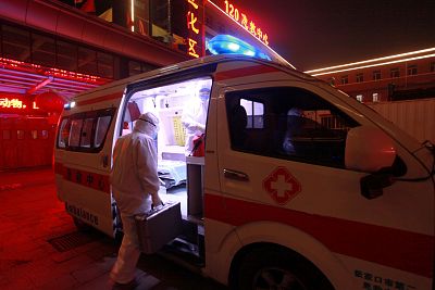 A medical worker in protective suit gets onto an ambulance at a hospital, following an outbreak of the novel coronavirus in the country, in Xuanhua district of Zhangjiakou, Hebei province, China Feb. 13.
