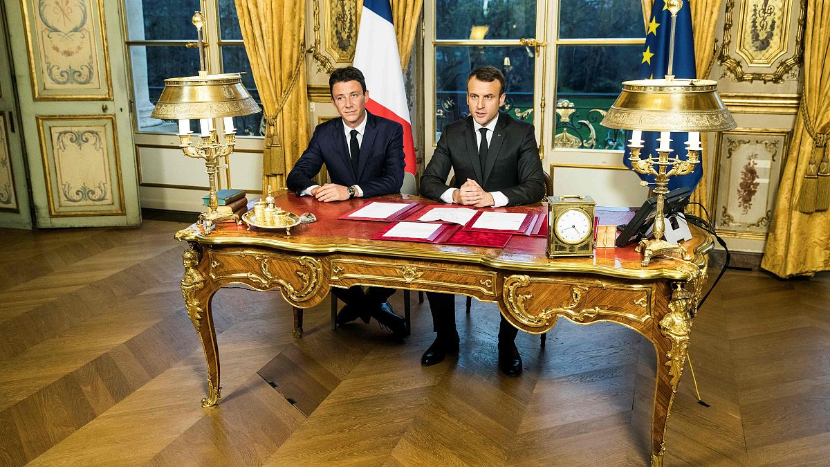 Image: French President Emmanuel Macron delivers a speech next to then spok