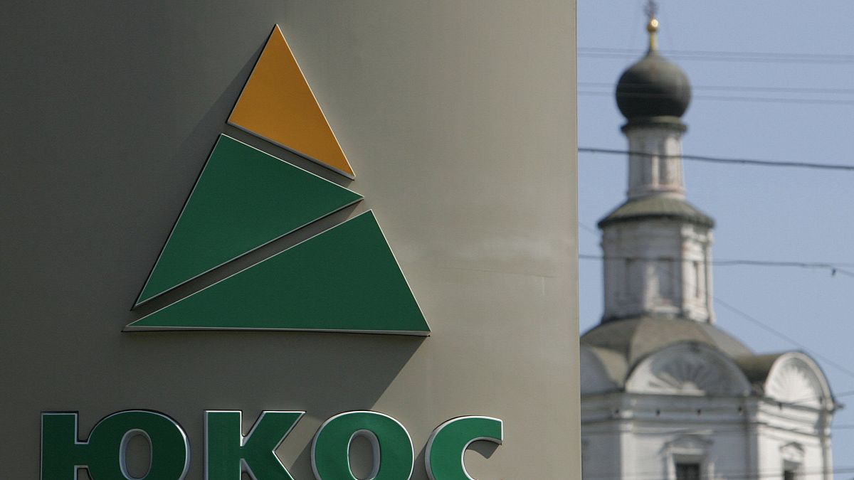 Image: The logo of Russian oil giant Yukos on a wall of a petrol station in