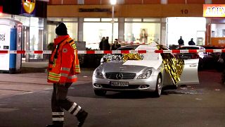 Image: A damaged car is seen after a shooting in Hanau near Frankfurt