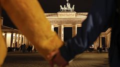 Image: People hold hands as they form a human chain, during a vigil for vic