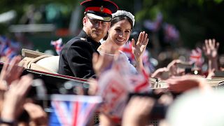 Image: Prince Harry and Meghan, Duchess of Sussex, wave from their carriage