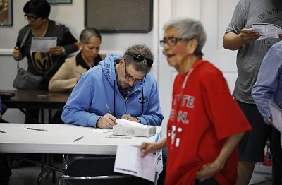 People fill out ballots to vote early at the Culinary Workers union, in Las Vegas on Feb. 17, 2020.