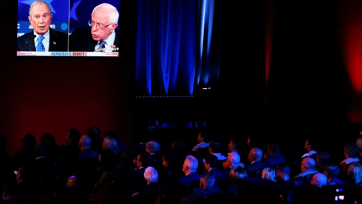Image: The audience watches Mike Bloomberg and Sen. Bernie Sanders speak at
