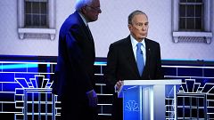 Image: Sen. Bernie Sanders walks behind Mike Bloomberg at a Democratic pres