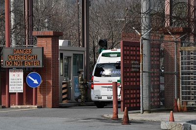 An ambulance drives through the main gate of US Army Camp Carroll in Chilgok, north of Daegu, on Wednesday. 