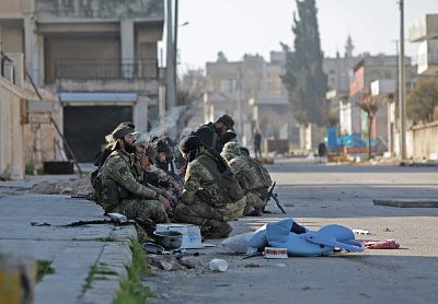 Turkey-backed Syrian fighters rest in the town of Saraqib in Syria\'s Idlib province on Thursday.