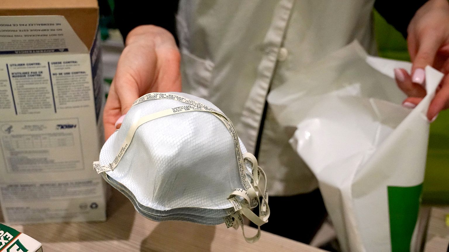 Image: A pharmacy worker sells N95 face masks in advance of the potential c