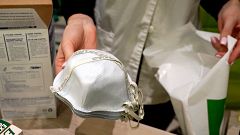 Image: A pharmacy worker sells N95 face masks in advance of the potential c