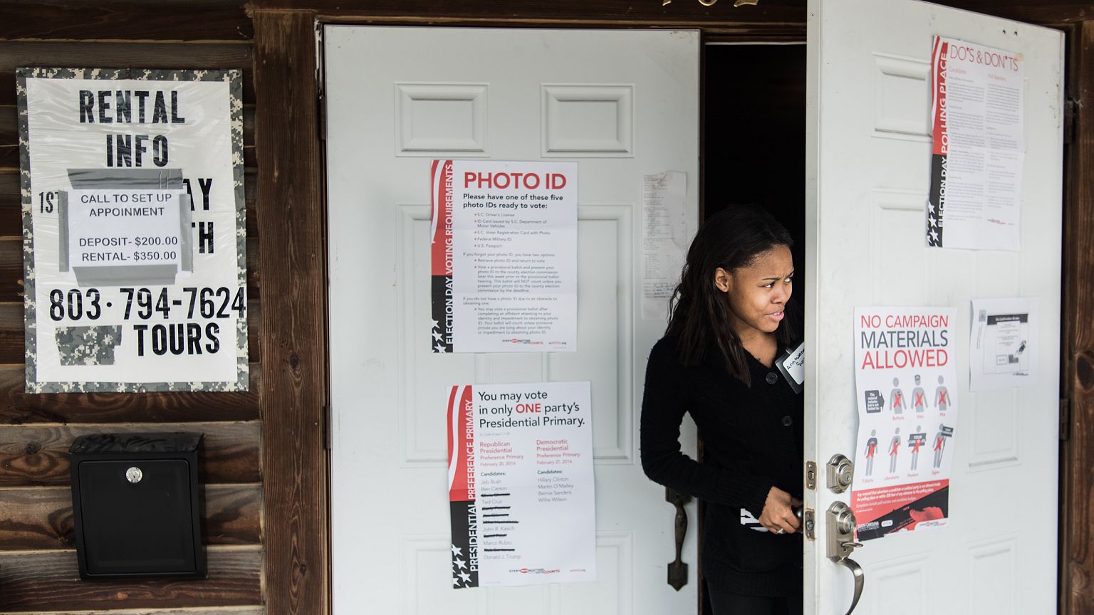 Image: A poll worker peeks out the door at American Legion Memorial Cayce P