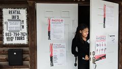 Image: A poll worker peeks out the door at American Legion Memorial Cayce P