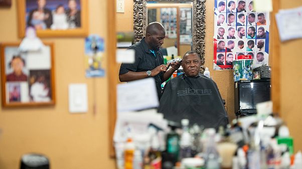 Image: Barber Anderson J. Washington with veteran Charles Peaks at CJ's Bar Image: Barber Anderson J. Washington with veteran Charles Peaks at CJ's Bar