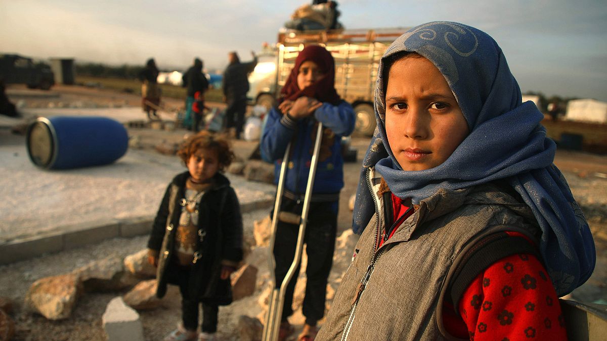 Image: Syrian children pose for a picture as their families prepare to flee