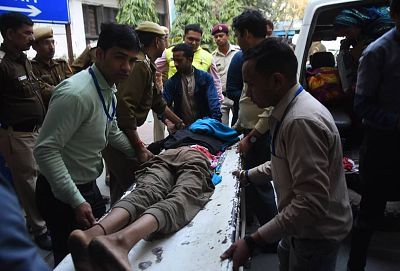 A teenager is taken to hospital after being shot in the waist in Kardam Puri, New Delhi on Tuesday, Feb. 25.