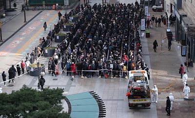 People wait to buy face masks outside a department store in Seoul on Tuesday.