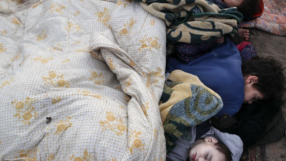 Image: Migrant children sleep on the pavement in Edirne near the Turkish-Gr