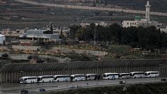 Image: Tourist buses wait at an Israeli checkpoint