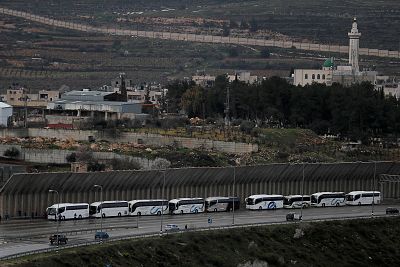 Tourist buses wait at an Israeli checkpoint as preventive measures are taken against the coronavirus, in Bethlehem in the Israeli-occupied West Bank, on Friday. 