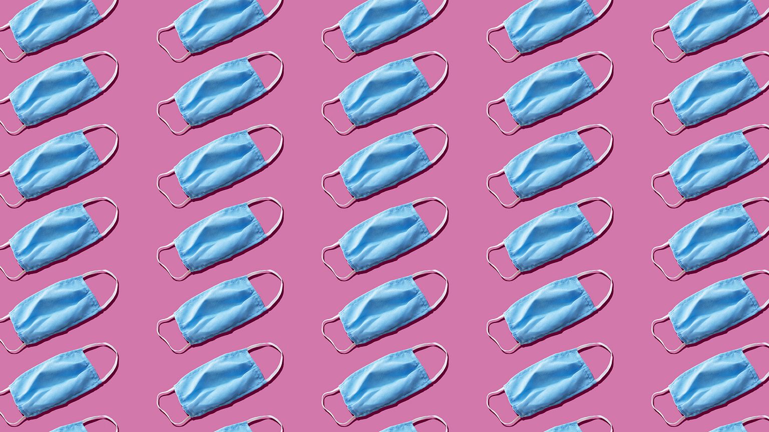 Blue medical face mask to avoid contagious diseases pattern on pink backgro