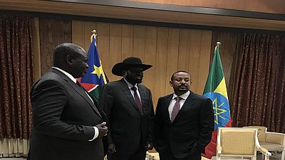 South Sudan's Salva Kiir and Riek Machar embrace at dinner hosted by Ethiopia PM