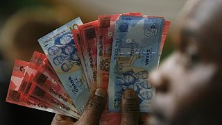 Ghana central bank merges five stressed banks, allays depositors' fears