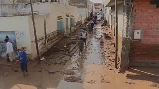 Tunisians wade through mud after floods