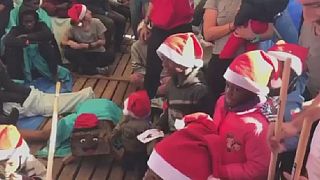 Migrant children receive Christmas gifts on charity boat